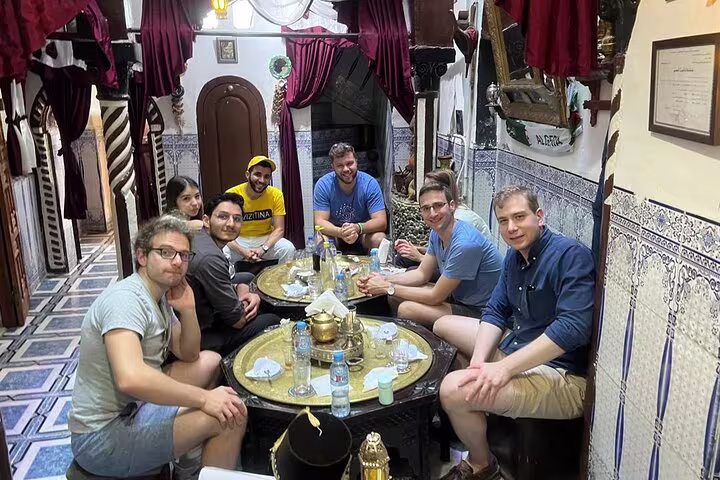 group of tourists sharing a traditional or a modern algerian dish meal lunch dinner